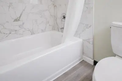 a bathroom with a white tub and a toilet at The Atwood Hotel San Diego - SeaWorld/Zoo in San Diego