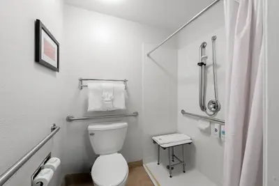 a small bathroom with a toilet and a shower at Comfort Inn Gaslamp Convention Center in San Diego
