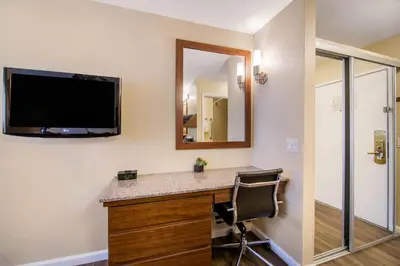a room with a desk with a television and a chair at Comfort Inn Gaslamp Convention Center in San Diego