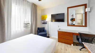 a hotel room with a bed and a mirror at Comfort Inn Gaslamp Convention Center in San Diego