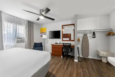 a hotel room with a bed and a desk with a computer at Comfort Inn Gaslamp Convention Center in San Diego