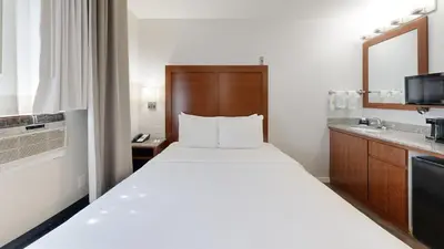 a hotel room with a large bed and a bathroom at Comfort Inn Gaslamp Convention Center in San Diego