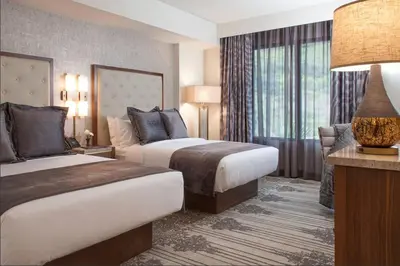 a hotel room with two beds and a large window at Legacy Resort Hotel & Spa in San Diego