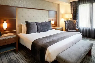 a hotel room with a large bed and a chair at Legacy Resort Hotel & Spa in San Diego