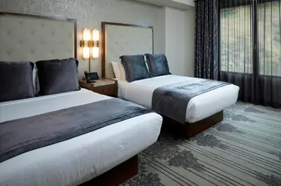 a hotel room with two beds and a window at Legacy Resort Hotel & Spa in San Diego
