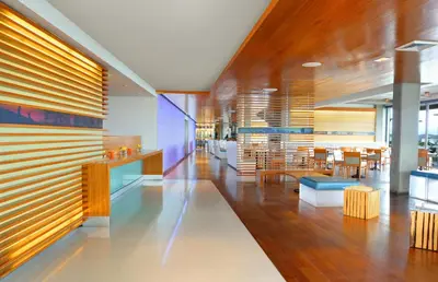 a lobby with tables and chairs in a building at Tower 23 Hotel in San Diego
