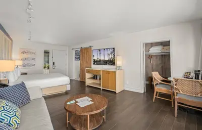 a hotel room with a bed and a table at Paradise Point Resort & Spa in San Diego