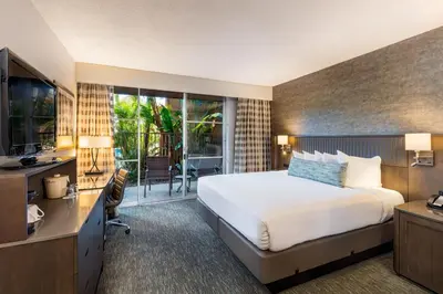 a hotel room with a bed and a desk and a television at Handlery Hotel San Diego in San Diego