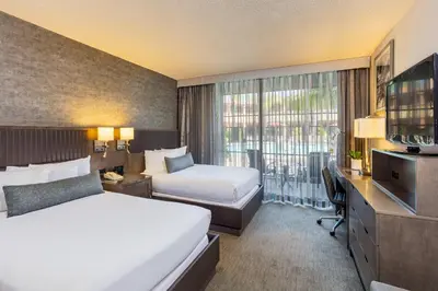 a hotel room with two beds and a television at Handlery Hotel San Diego in San Diego