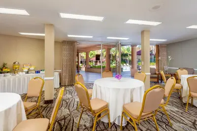 a room with a table and chairs and a kitchen at Handlery Hotel San Diego in San Diego