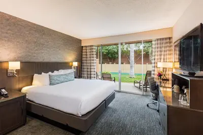 a hotel room with a bed and a flat screen tv at Handlery Hotel San Diego in San Diego