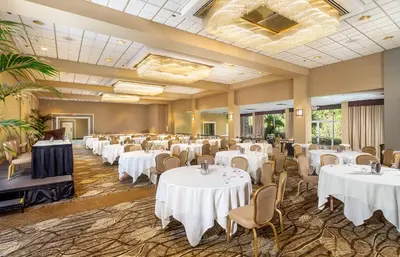 a banquet hall with white tables and chairs at Handlery Hotel San Diego in San Diego