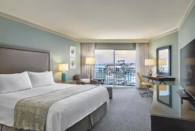 a hotel room with a bed and a balcony at Loews Coronado Bay Resort in San Diego