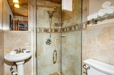 a bathroom with a shower and a sink at Penthouse Condo w/ Panoramic Ocean Views at Beach Resort in Oceanside