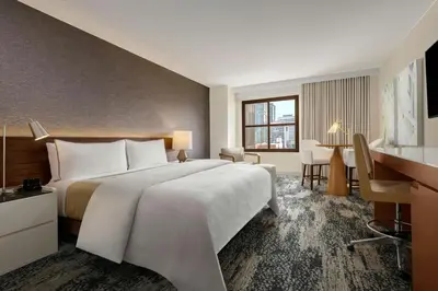 a hotel room with a large bed and a desk at The Westin San Diego Gaslamp Quarter in San Diego