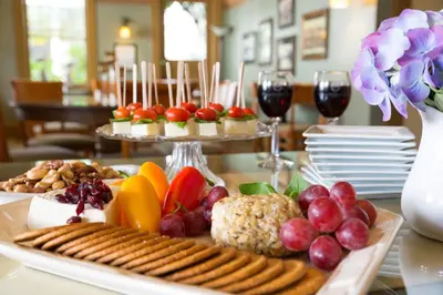 a table with a tray of food and wine glasses at 1906 Lodge in San Diego