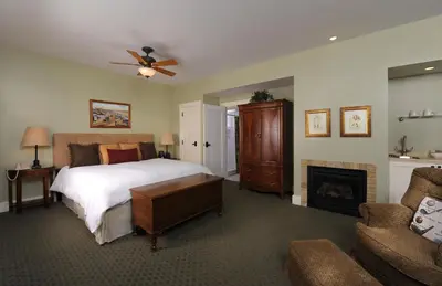 a bedroom with a bed and a fireplace at 1906 Lodge in San Diego
