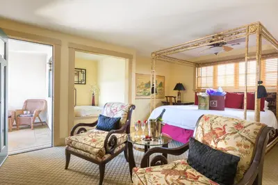 a bedroom with a bed and a table and chairs at 1906 Lodge in San Diego