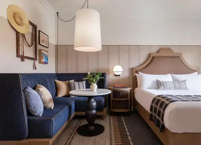 a hotel room with a bed and a couch at Estancia La Jolla Hotel & Spa in San Diego
