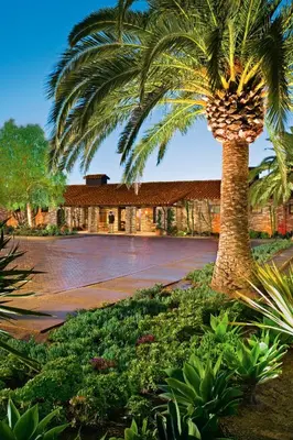 a palm tree in front of a building at Estancia La Jolla Hotel & Spa in San Diego