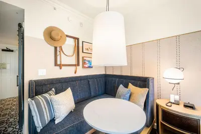 a living room with a couch and a table at Estancia La Jolla Hotel & Spa in San Diego