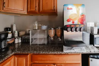 a kitchen with a counter with a refrigerator at Old Town Western Inn in San Diego