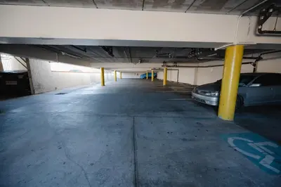 an empty parking garage with a car parked in it at Old Town Western Inn in San Diego