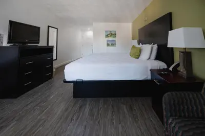 a hotel room with a bed and a television at Old Town Western Inn in San Diego