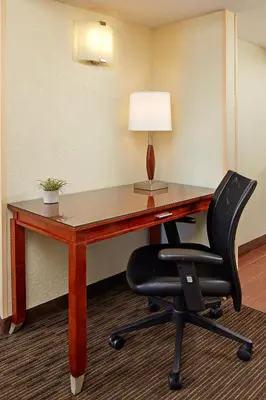 a desk with a lamp and a chair in a room at Mission View Inn & Suites San Diego Sea World - Zoo in San Diego