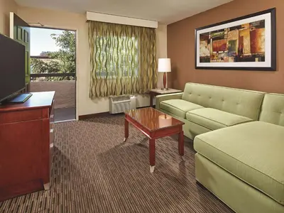 a living room with a couch and a tv at Mission View Inn & Suites San Diego Sea World - Zoo in San Diego