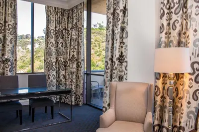 a living room with a desk and a chair at Sheraton Mission Valley San Diego Hotel in San Diego