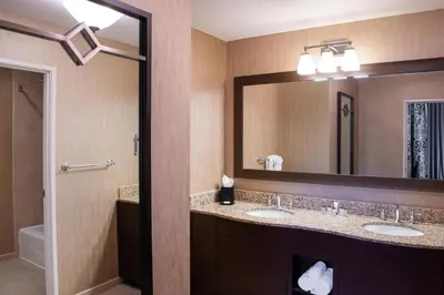 a bathroom with two sinks and a large mirror at Sheraton Mission Valley San Diego Hotel in San Diego