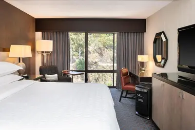 a hotel room with a bed and a large window at Sheraton Mission Valley San Diego Hotel in San Diego