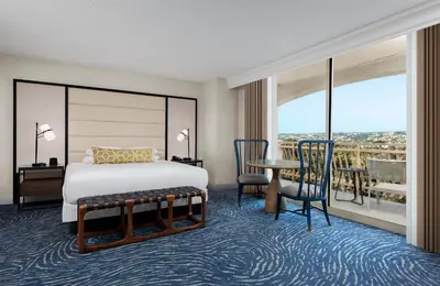 a bedroom with a bed and a table and chairs at San Diego Mission Bay Resort in San Diego