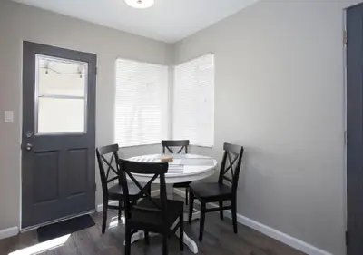 a dining room with a table and chairs and a window at MB Jamaica FLAT - Steps 2 Mission Beach in San Diego