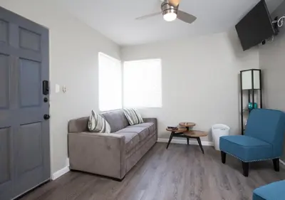 a living room with a couch and a blue chair at MB Jamaica FLAT - Steps 2 Mission Beach in San Diego