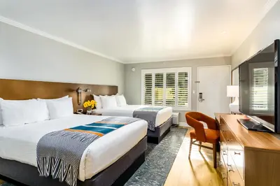 a hotel room with two beds and a flat screen tv at Town and Country San Diego in San Diego