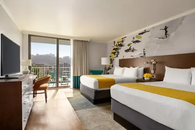 a hotel room with two beds and a television at Town and Country San Diego in San Diego