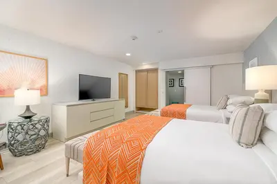 a hotel room with two beds and a flat screen tv at Beach Terrace in Carlsbad