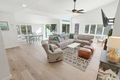 a living room with a couch and a table at Beachfront feat Private Den SS166 in Solana Beach