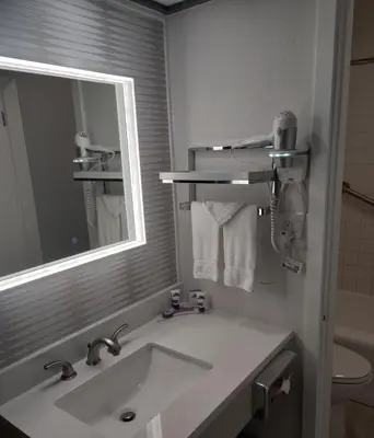 a bathroom with a sink and a mirror at Kings Inn in San Diego