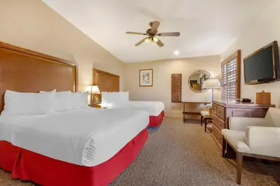 a hotel room with two beds and a flat screen tv at Best Western Plus Hacienda Hotel Old Town in San Diego