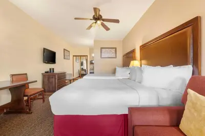 a hotel room with a large bed and a couch at Best Western Plus Hacienda Hotel Old Town in San Diego