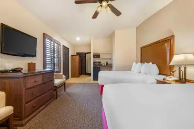 a hotel room with a bed and a flat screen tv at Best Western Plus Hacienda Hotel Old Town in San Diego