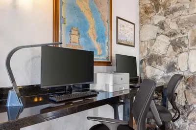 a desk with a computer monitor and a printer at Best Western Plus Hacienda Hotel Old Town in San Diego