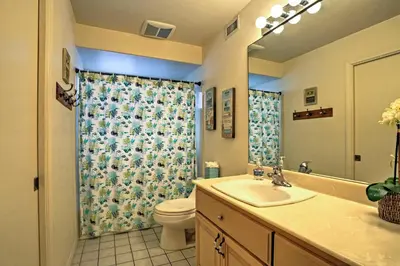 a bathroom with a sink and a toilet and a mirror at Beachfront San Diego Condo with Patio on the Bay! in San Diego