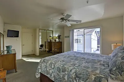 a bedroom with a bed and a ceiling fan at Beachfront San Diego Condo with Patio on the Bay! in San Diego