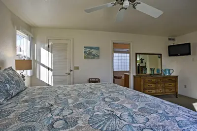 a bedroom with a bed and a ceiling fan at Beachfront San Diego Condo with Patio on the Bay! in San Diego