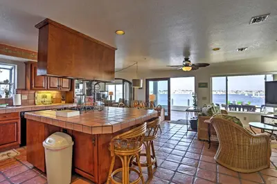 a kitchen with a large island in the middle of a room at Beachfront San Diego Condo with Patio on the Bay! in San Diego
