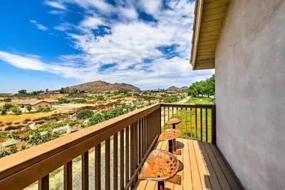 a balcony with two chairs and a view of the mountains at Luxe Wine Country Estate with Orchard-Facing Balcony in Temecula
